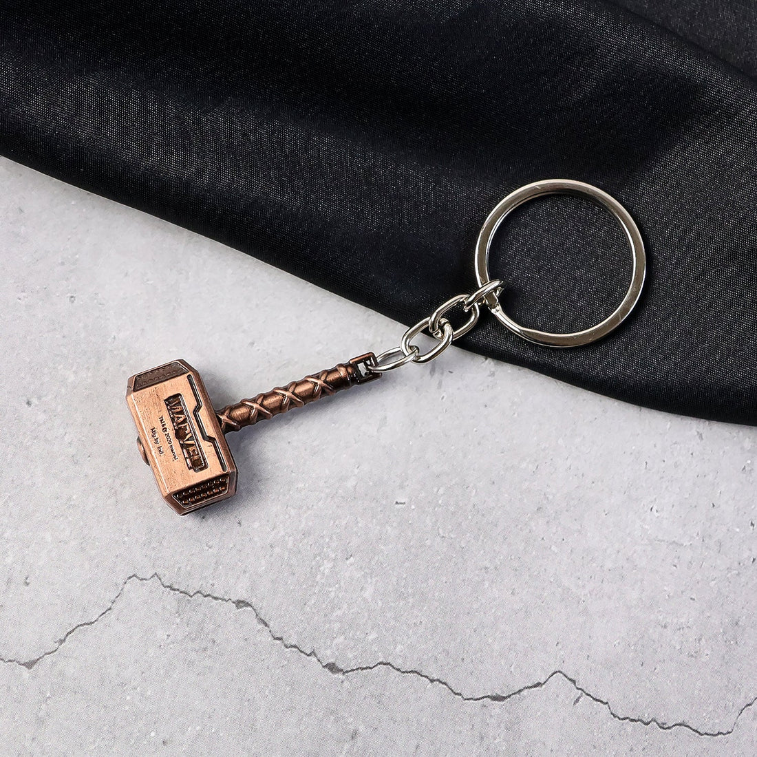 Metal Hammer Keychain with antique bronze finish on neutral background