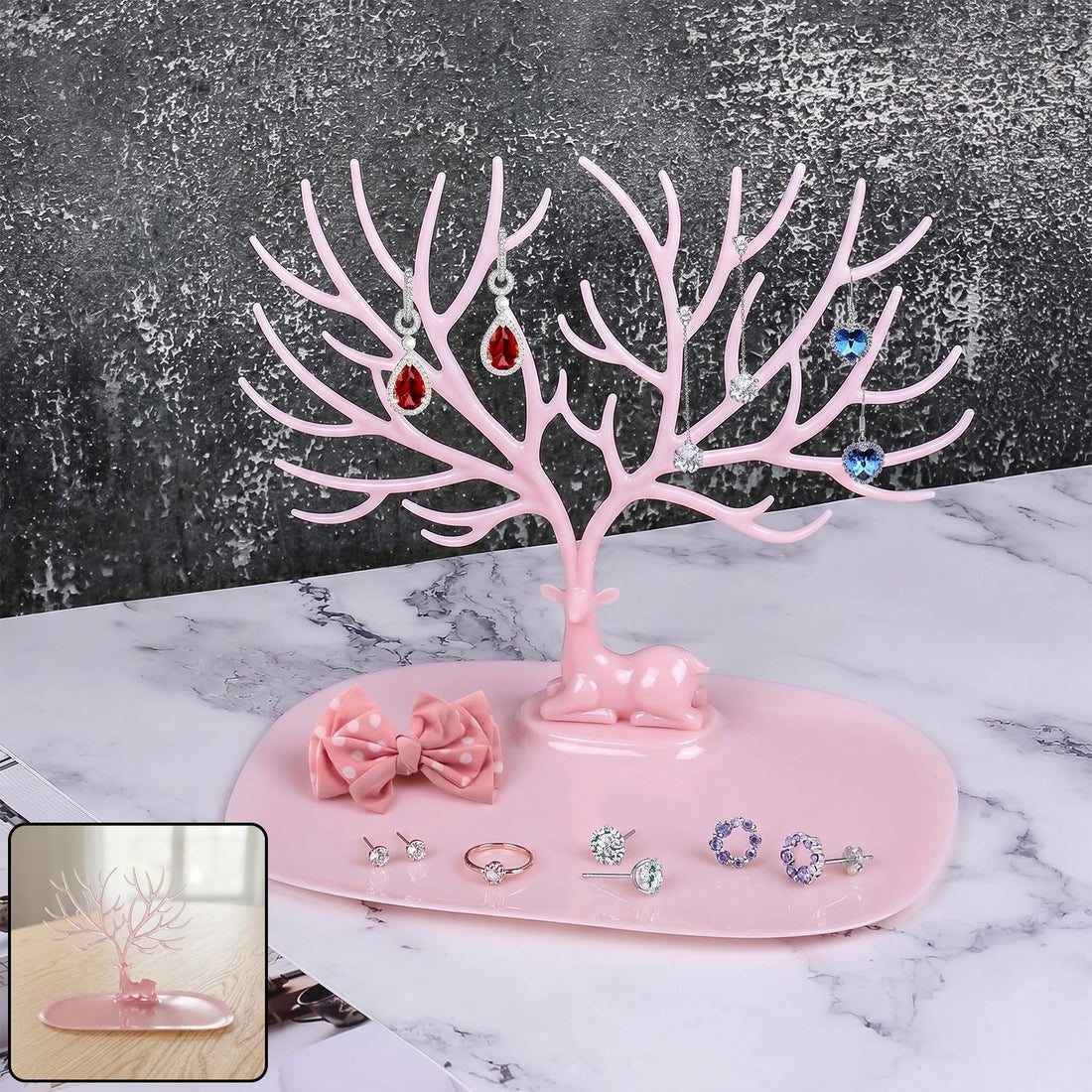 Pink deer-shaped jewelry stand with tree branches for earrings and rings, India